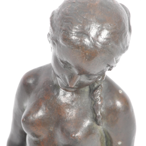 641 - An early 20th Century bronze figurine statue study of a reclining nude lady. The figure resting on p... 