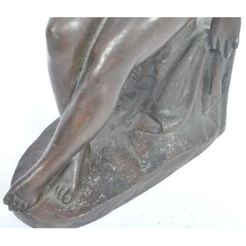 641 - An early 20th Century bronze figurine statue study of a reclining nude lady. The figure resting on p... 