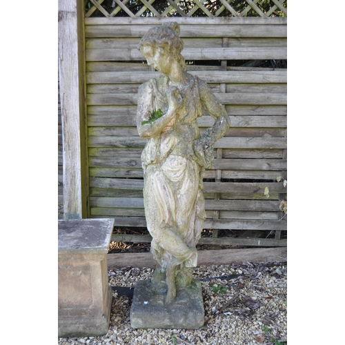 666 - A large 19th Century garden statue figurine in the form of a classical maiden, The figure dressed in... 