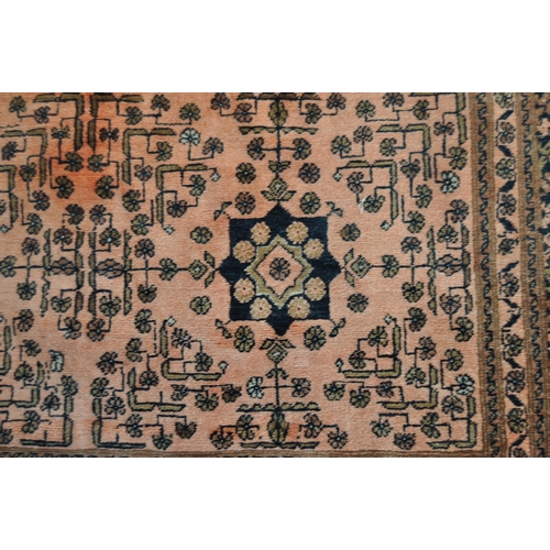 668 - A large early 20th Century Persian Islamic floor carpet rug having a red ground with central panel h... 