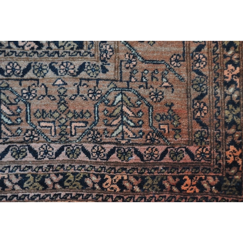 668 - A large early 20th Century Persian Islamic floor carpet rug having a red ground with central panel h... 