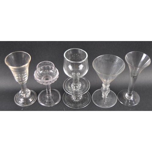 76 - A group of five glass wine drinking glasses comprising a bell shaped bowl with large bladed stem, tr... 