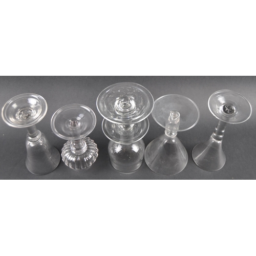 76 - A group of five glass wine drinking glasses comprising a bell shaped bowl with large bladed stem, tr... 