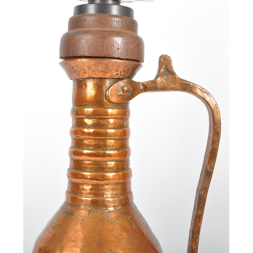 93 - A late 18th Century upcycled hammered copper ewer jug having been converted into a table lamp. The j... 