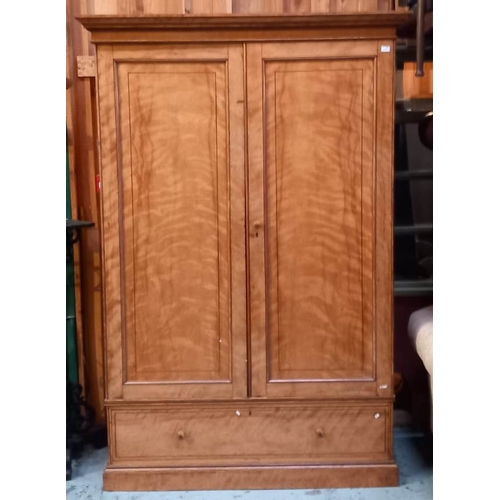 38 - A large 19th Century Victorian satin birch wardrobe in the manner of Maple & Co. Fielded panel doors... 