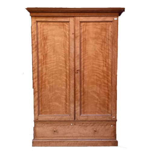 38 - A large 19th Century Victorian satin birch wardrobe in the manner of Maple & Co. Fielded panel doors... 