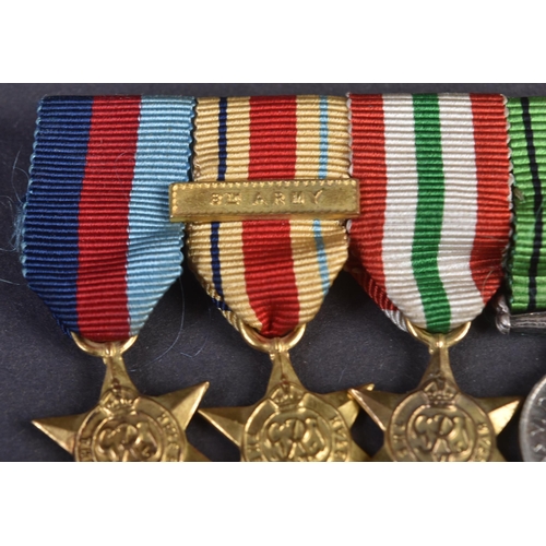 126 - A WWII Second World War miniature medal group suspended on original ribbons and mounted onto a bar. ... 