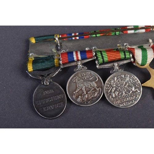 126 - A WWII Second World War miniature medal group suspended on original ribbons and mounted onto a bar. ... 