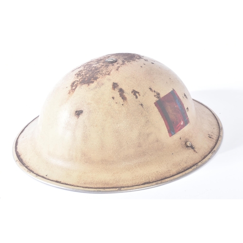 179 - A WWII Second World War British Royal Engineers MKII steel combat helmet. Tan desert body with a red... 