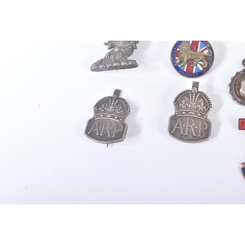 196 - A collection of assorted WWII Second World War and other cap badges / lapel pin badges to include; S... 