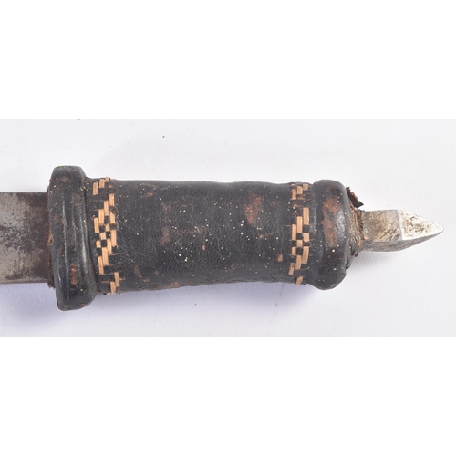 209 - A 19th Century Sudanese leather clad double edged tribal dagger / knife. Housed within its original ... 