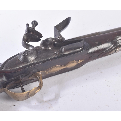 300 - A late 18th Century French flintlock pistol. Shaped brass trigger guard, with roundel to butt. Ramro... 