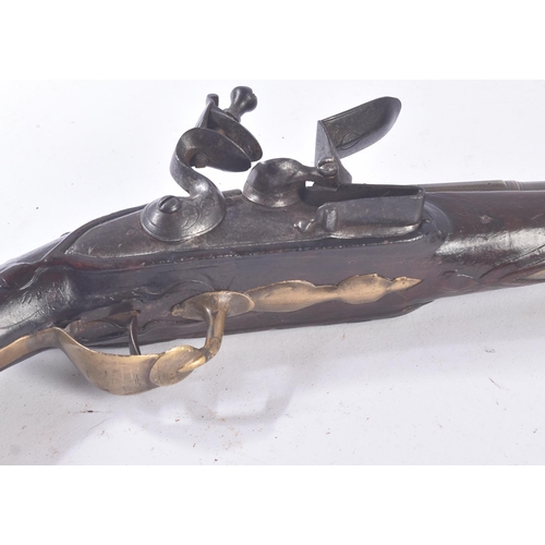 300 - A late 18th Century French flintlock pistol. Shaped brass trigger guard, with roundel to butt. Ramro... 