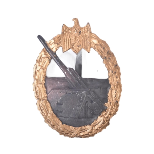 393 - A WWII Second World War Third Reich Nazi German Kriegsmarine Coastal Artillery war badge. The centra... 