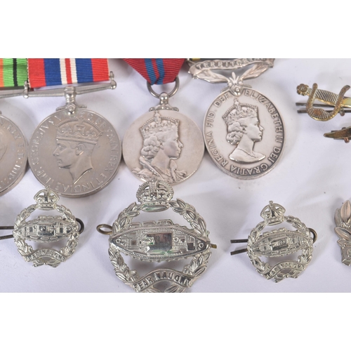 397 - A WWII Second World War medal group and a selection of cap badges comprising Royal Tank Regiment and... 