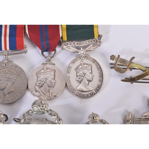 397 - A WWII Second World War medal group and a selection of cap badges comprising Royal Tank Regiment and... 