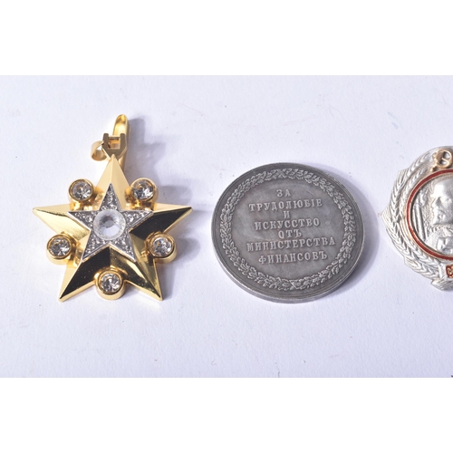 398 - A collection of assorted 20th Century Russian Military medals and badges comprising; a gold plated M... 