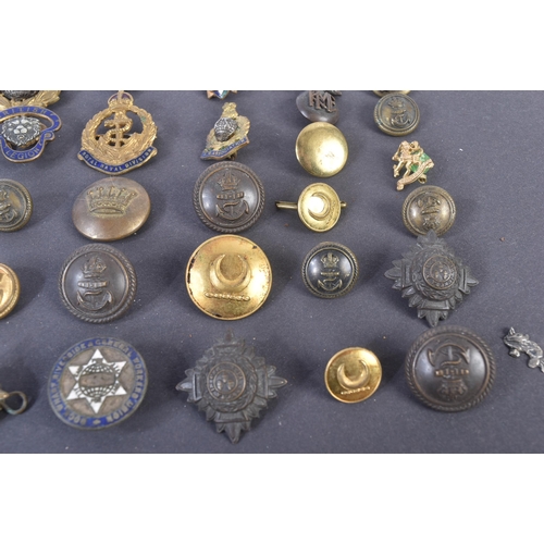 59 - A collection of assorted 20th Century (WWII and surrounding period) military related buttons, badges... 