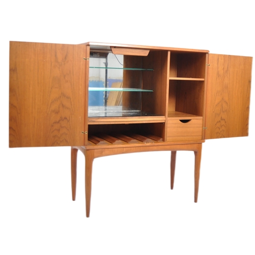 30 - A retro vintage mid 20th Century 1960s Danish teak cocktail drinks cabinet having two full length do... 