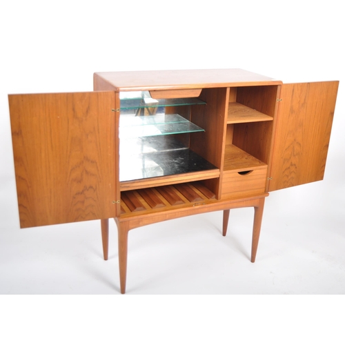 30 - A retro vintage mid 20th Century 1960s Danish teak cocktail drinks cabinet having two full length do... 