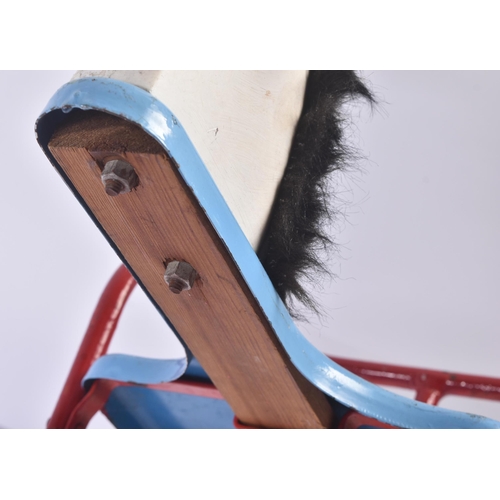 108 - A vintage Triang / Tri-ang childrens rocking horse on a red metal frame with blue seat and a moulded... 