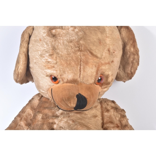 154 - A vintage 1960s Merrythought made soft toy ' Cheeky '  teddy bear. Golden mohair with bells in the e... 