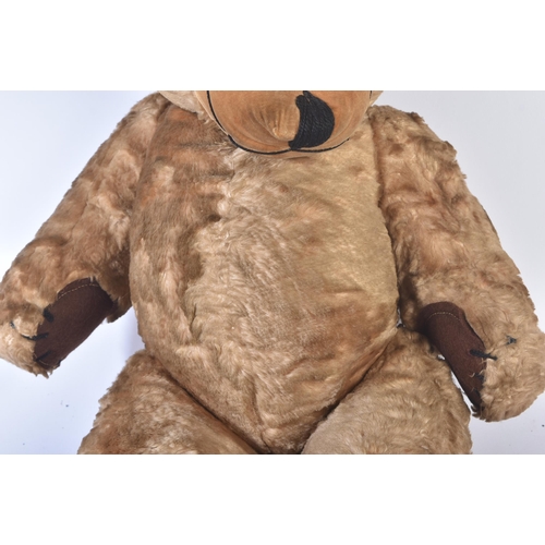 154 - A vintage 1960s Merrythought made soft toy ' Cheeky '  teddy bear. Golden mohair with bells in the e... 