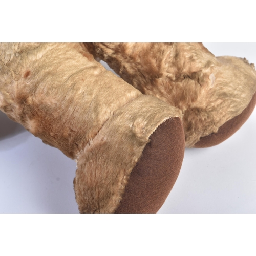 154 - A vintage 1960s Merrythought made soft toy ' Cheeky '  teddy bear. Golden mohair with bells in the e... 
