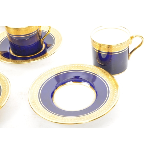 10 - A set of six Aynsley bone china coffee cups and saucers, with gold gilding scrollwork to cup edge an... 