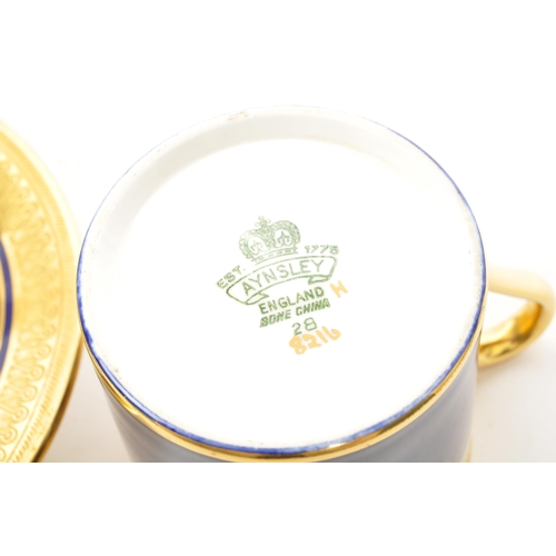 10 - A set of six Aynsley bone china coffee cups and saucers, with gold gilding scrollwork to cup edge an... 