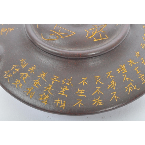 117 - A pair of 20th century Chinese terracotta teapots to include a squat example with engraved script to... 