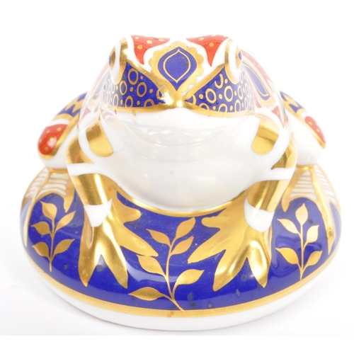 142 - A Royal Crown Derby Imari pattern toad paperweight with gold stopper.