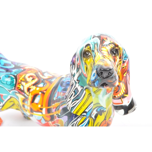 154 - A contemporary resin multicolour graffiti street art urban Basset hound sausage dog ornament figurin... 