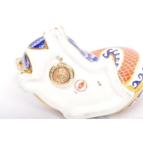 160 - A Royal Crown Derby Imari pattern dragon with gold stopper and marks to base.