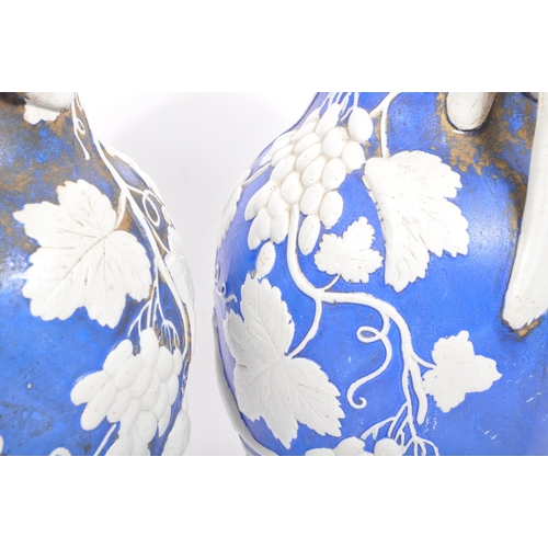 173 - A pair of 19th century Victorian ceramic pottery blue and white lidded vases. With twin handles whit... 