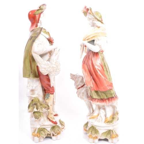 177 - A pair of early 20th century continental bisque ware figures depiciting a classical couple. With a g... 