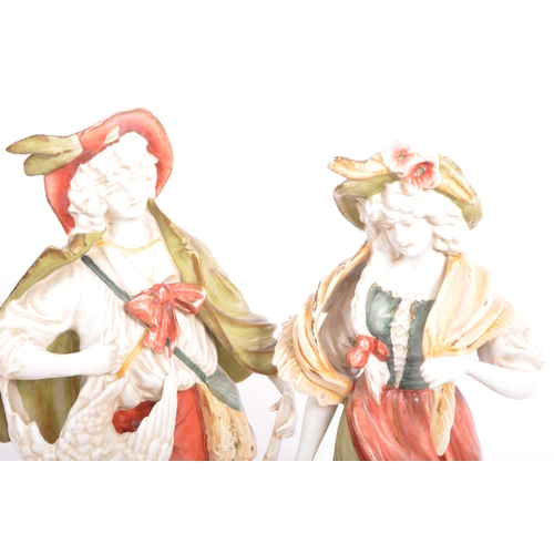 177 - A pair of early 20th century continental bisque ware figures depiciting a classical couple. With a g... 