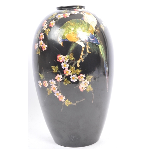 179 - A vintage 20th century Bretby aesthetic movement black glazed high shouldered vase, painted with bir... 