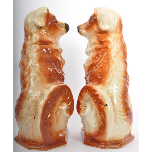 18 - A pair of 20th Century fire side mantel Staffordshire style wally dogs. In a seated position with gi... 