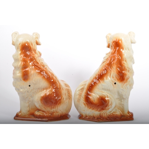 18 - A pair of 20th Century fire side mantel Staffordshire style wally dogs. In a seated position with gi... 