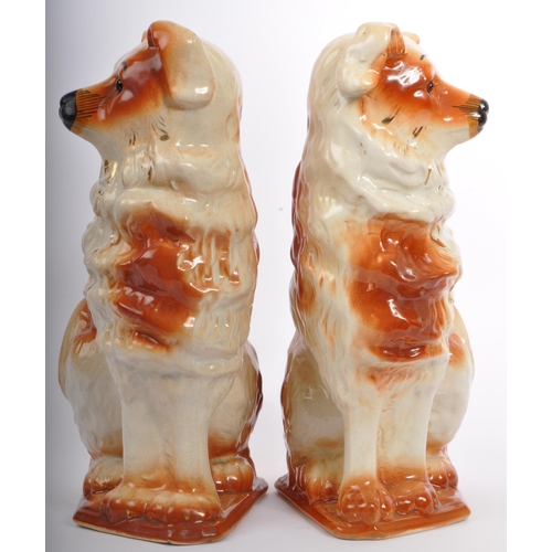 18 - A pair of 20th Century fire side mantel Staffordshire style wally dogs. In a seated position with gi... 