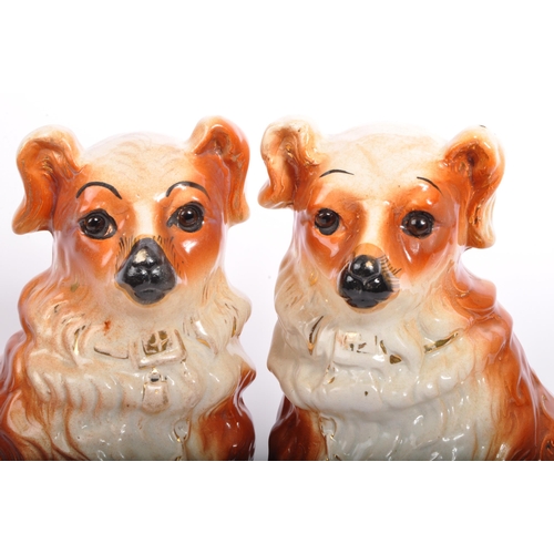 18 - A pair of 20th Century fire side mantel Staffordshire style wally dogs. In a seated position with gi... 