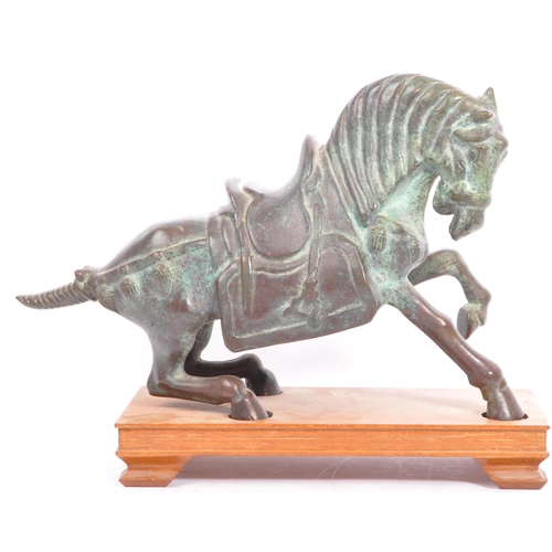 200 - A detailed 20th Century patinated effect brass figurine of a stylised horse upon a wooden plinth. Me... 