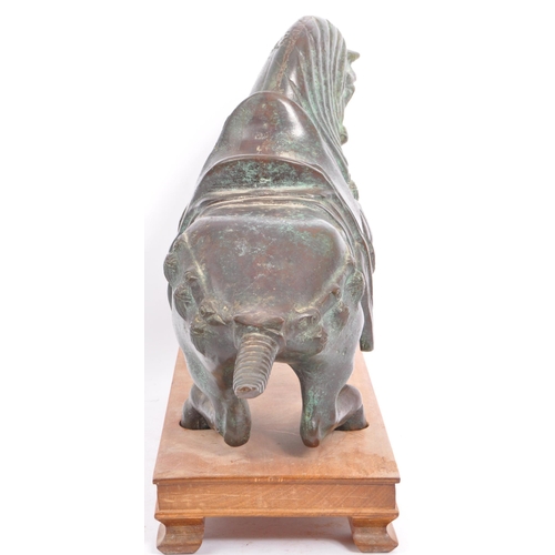 200 - A detailed 20th Century patinated effect brass figurine of a stylised horse upon a wooden plinth. Me... 