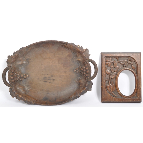 205A - A early to mid 20th century Black Forest carved wooden tray with grape and vine carving. Along with ... 