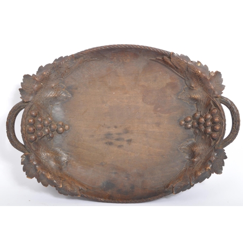 205A - A early to mid 20th century Black Forest carved wooden tray with grape and vine carving. Along with ... 