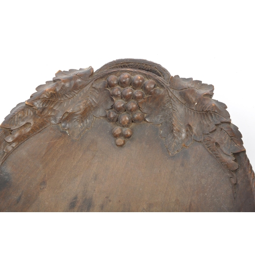 205A - A early to mid 20th century Black Forest carved wooden tray with grape and vine carving. Along with ... 