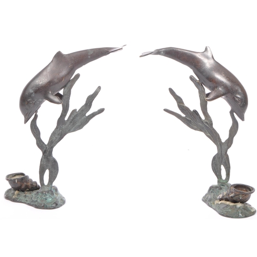 207A - A pair of early 20th century bronze figural decorative aesthetic candlestick holders in the shaped o... 