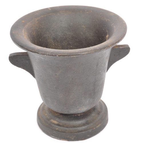 208 - An early 20th cast metal pestle and mortar having lipped rim with canted handles to each side on a c... 