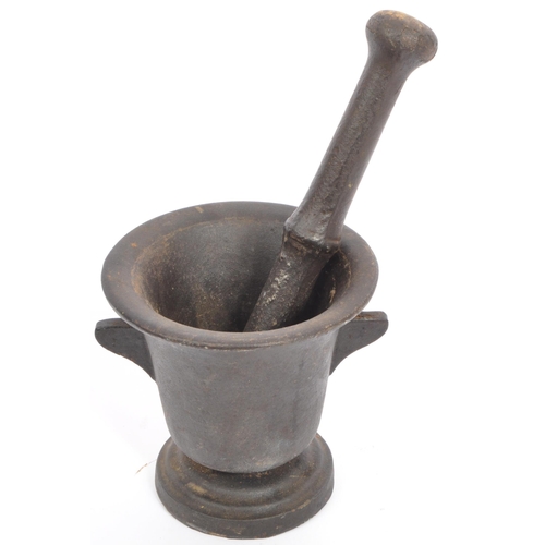 208 - An early 20th cast metal pestle and mortar having lipped rim with canted handles to each side on a c... 